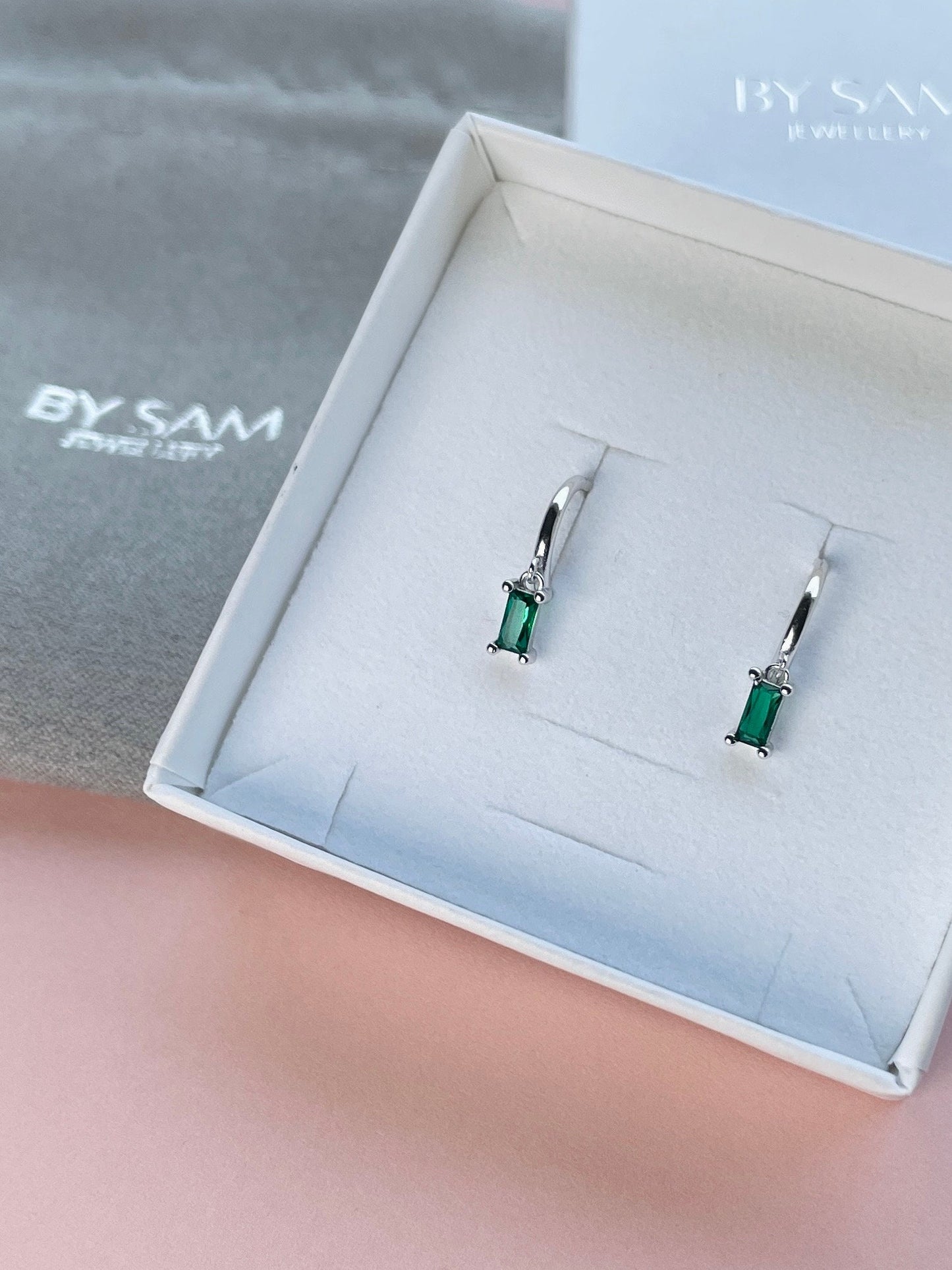 Emerald huggie earrings