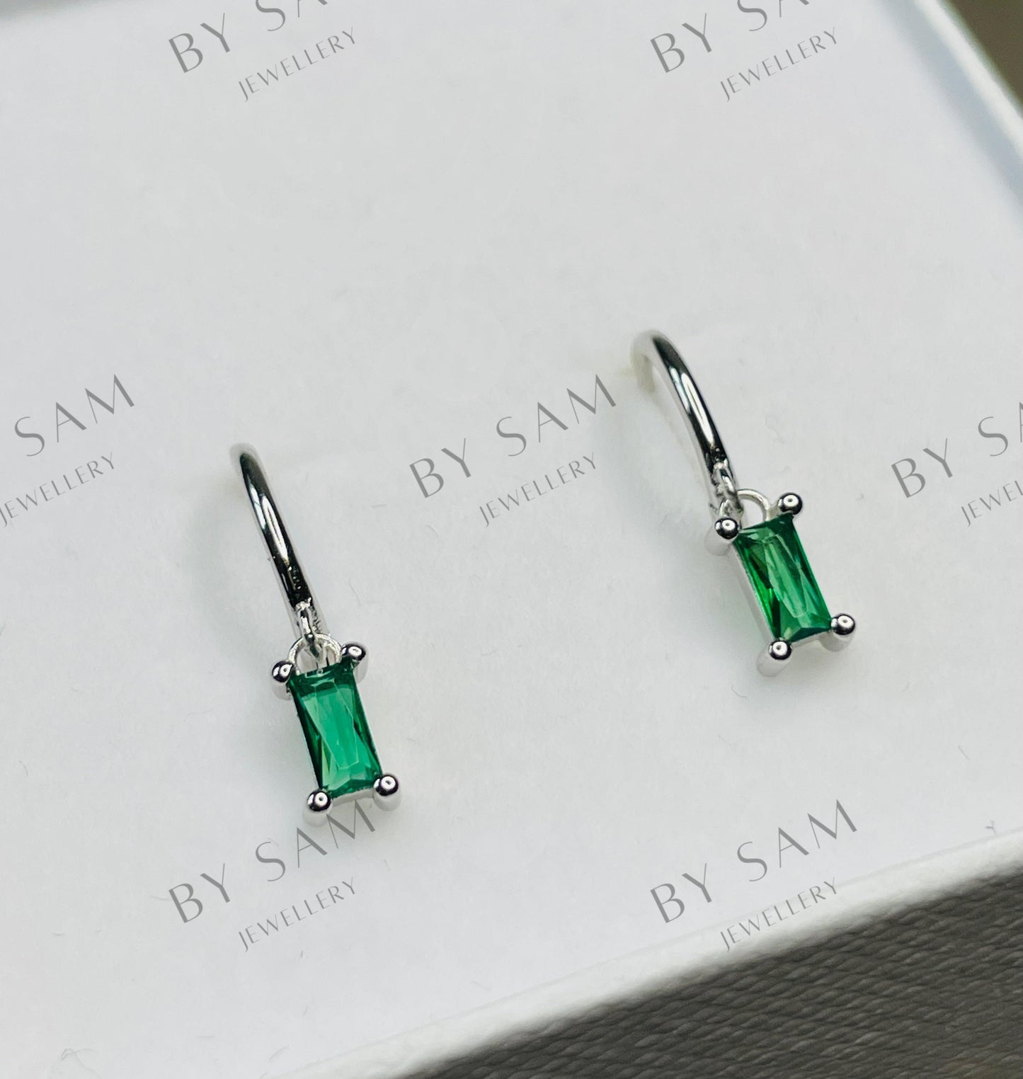 Emerald huggie earrings